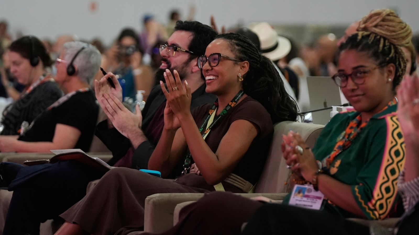 Delegates cheer at the passing of an article during a plenary session at COP30. Pic: AP