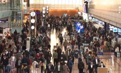 Passengers wait at Haneda Airport in Tokyo after delays from an Airbus software glitch. Pic: AP / NTV