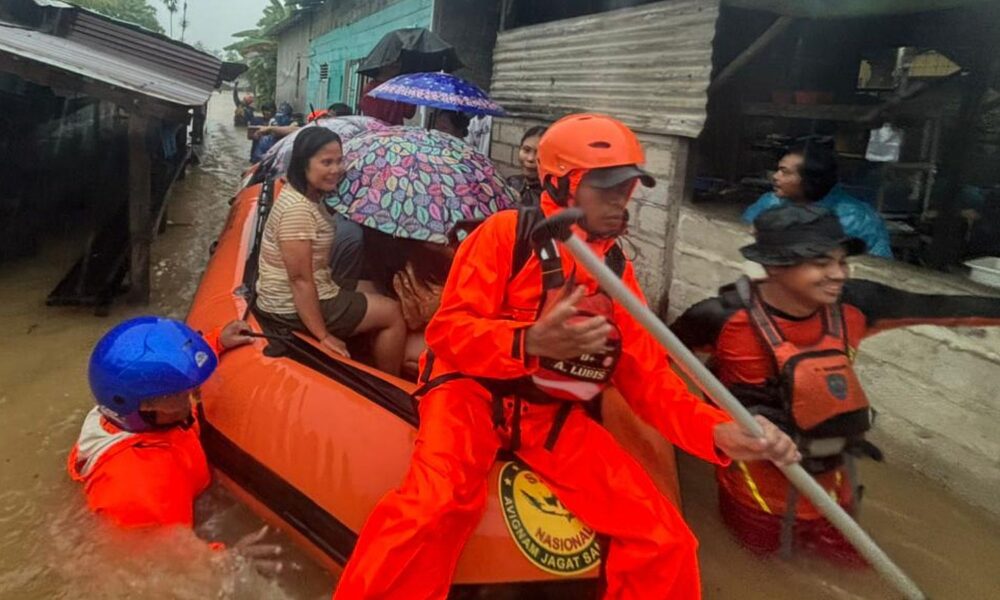 Residents are evacuated from their flooded home in North Sumatra province, Indonesia. Pic: AP