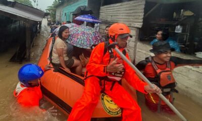Residents are evacuated from their flooded home in North Sumatra province, Indonesia. Pic: AP