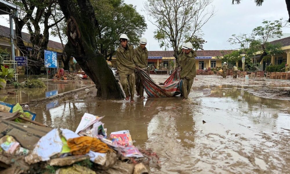 People clean up after flood recedes in Dak Lak on 24 November. Pic: Nguyen Dung/VNA via AP