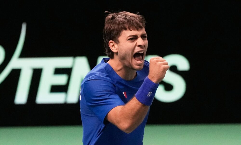 Italy's Flavio Cobolli celebrates after winning a Davis Cup final singles tennis match against Spain's Jaume Munar, in Bologna, Italy, Sunday, Nov. 23, 2025. (AP Photo/Luca Bruno)