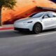 Tesla Model Y Standard model in white driving on a road in LA
