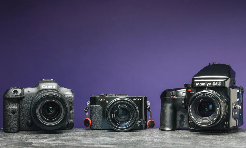 An image of three cameras with a purple background