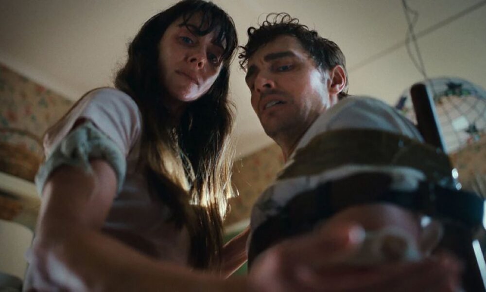 A couple looking down at one of their hands in Neon body horror movie Together