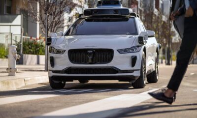 A Waymo Jaguar I-Pace drives on a road