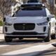 A Waymo Jaguar I-Pace drives on a road