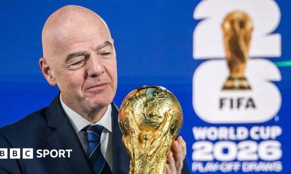 Fifa president Gianni Infantino holding the World Cup