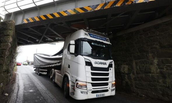 In pictures: Lorry gets wedged after crashing into railway bridge