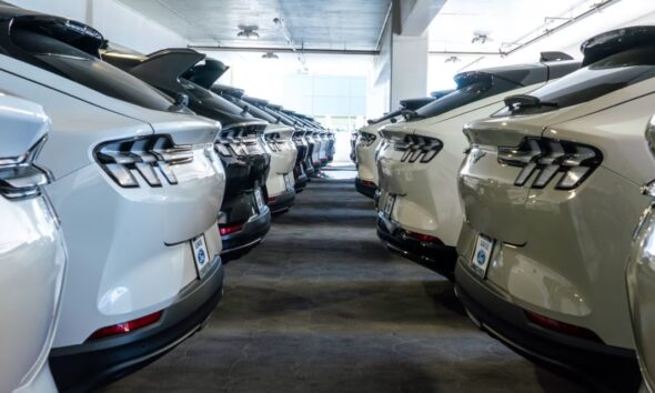 Ford Mustang Mach-E EV vehicles at a California dealership. The company is scaling back its electric-vehicle ambitions.