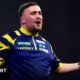 Luke Littler celebrates winning a set against Rob Cross at the PDC World Championships