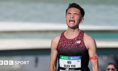 Alex Yee celebrates as he crosses the finish line at the Valencia Marathon