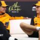 Lando Norris and Oscar Piastri look at each other during the news conference in Abu Dhabi