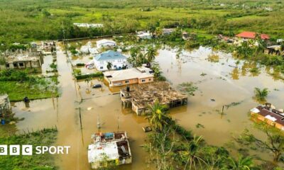 Jamaica netball player Shanice Beckford holds an aid package