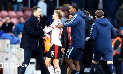 Players from both sides are involved in a melee on the pitch at St Mary's