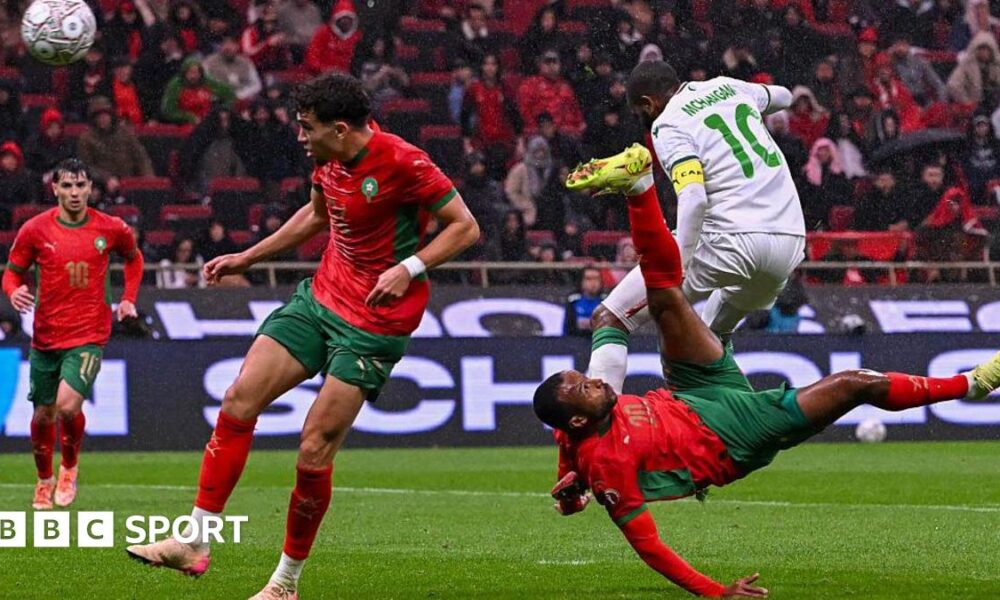 Morocco's Ayoub El Kaabi (right) scores against Comoros