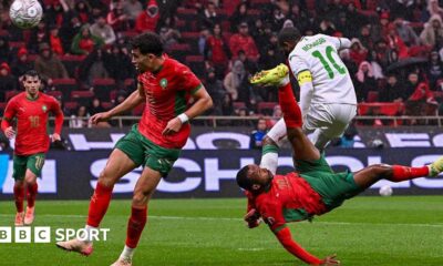 Morocco's Ayoub El Kaabi (right) scores against Comoros