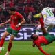 Morocco's Ayoub El Kaabi (right) scores against Comoros