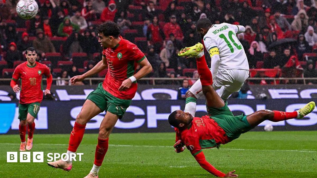 Morocco's Ayoub El Kaabi (right) scores against Comoros