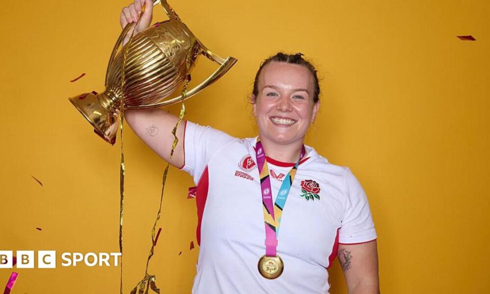 Lark Atkin-Davies holding the Rugby World Cup trophy