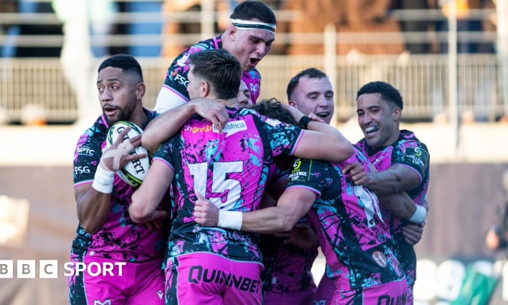 Six Ospreys players in a huddle celebrating scoring a try in their win at Montauban in the Challenge Cup