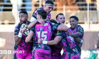 Six Ospreys players in a huddle celebrating scoring a try in their win at Montauban in the Challenge Cup