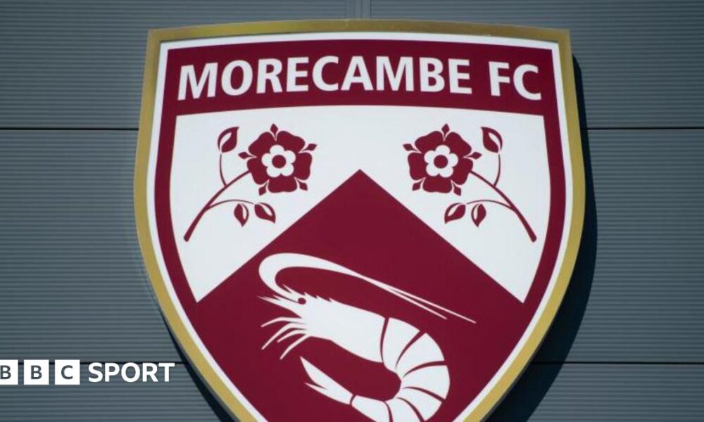 A shot of Morecambe's badge on the exterior of their Mazuma Mobile Stadium