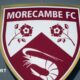 A shot of Morecambe's badge on the exterior of their Mazuma Mobile Stadium