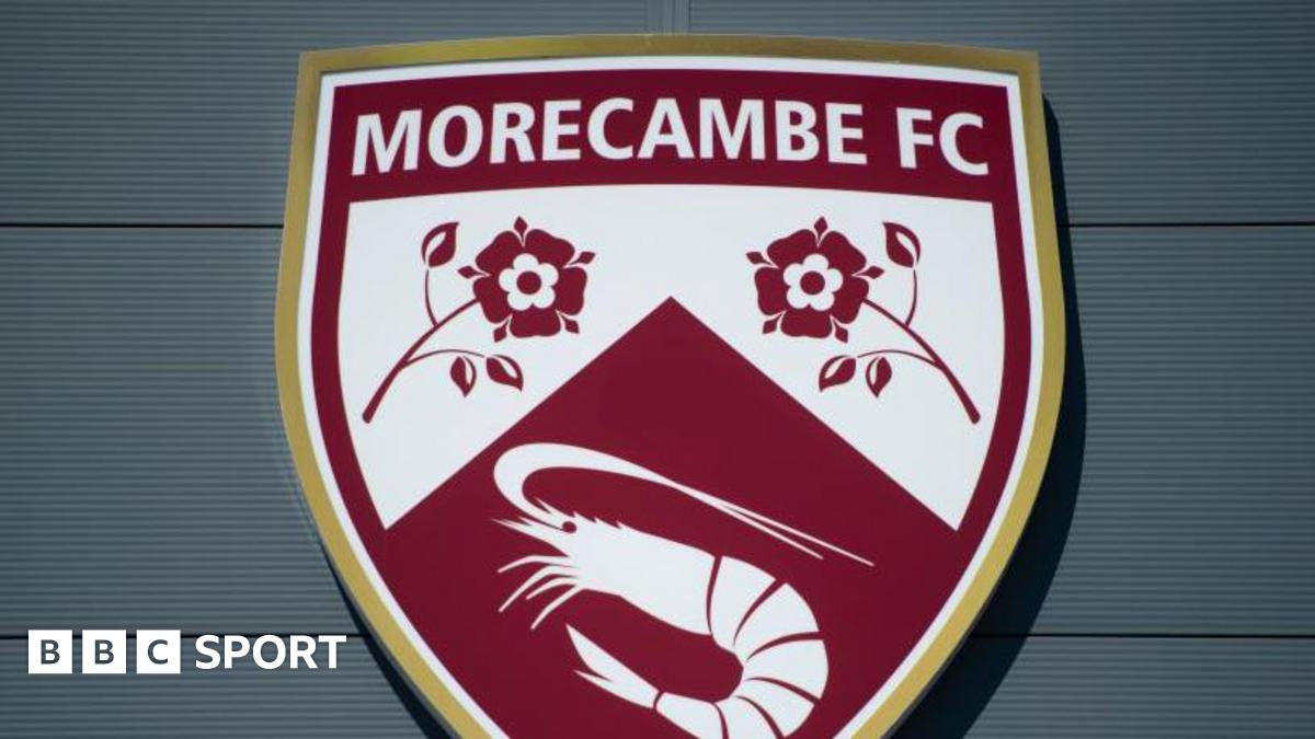 A shot of Morecambe's badge on the exterior of their Mazuma Mobile Stadium
