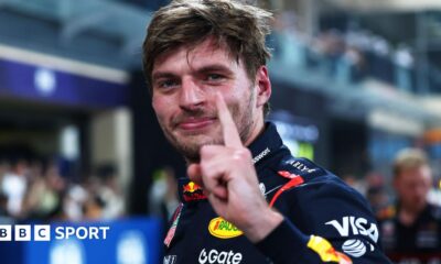 Max Verstappen lifts his left index finger in celebration after taking pole position for the Abu Dhabi Grand Prix
