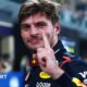 Max Verstappen lifts his left index finger in celebration after taking pole position for the Abu Dhabi Grand Prix