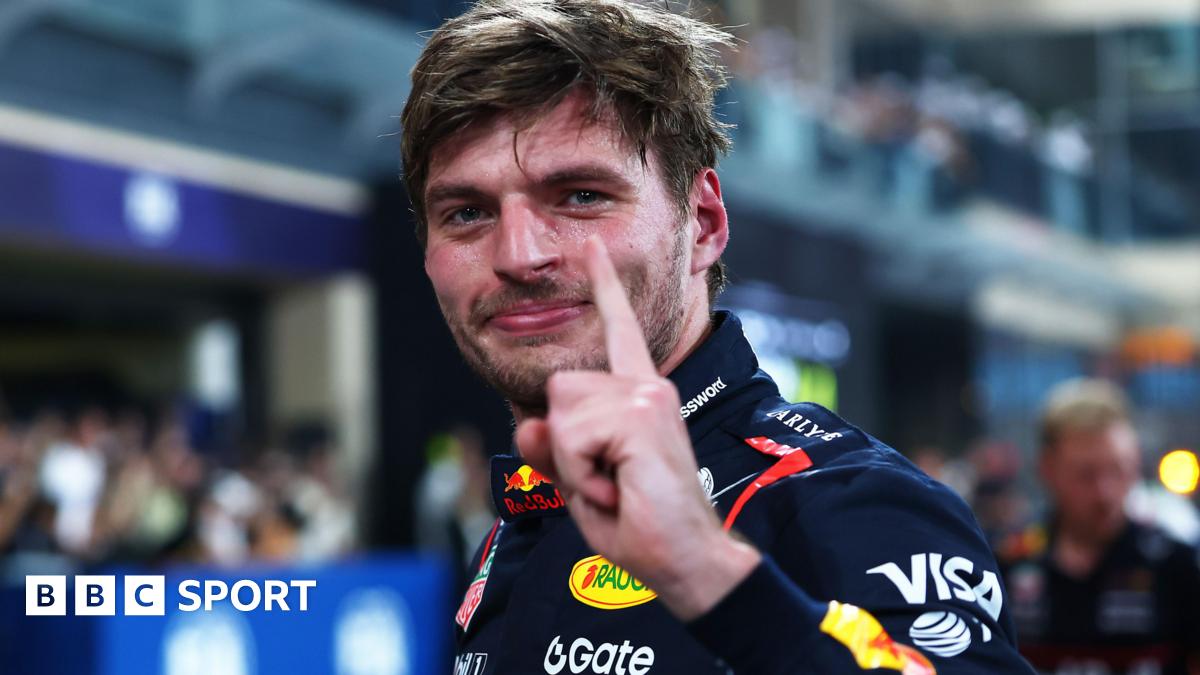 Max Verstappen lifts his left index finger in celebration after taking pole position for the Abu Dhabi Grand Prix