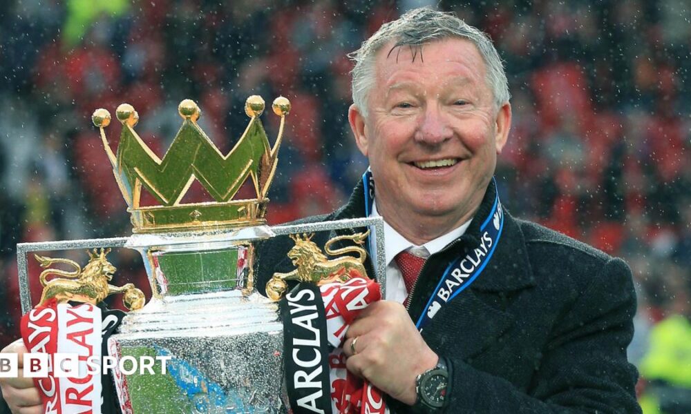 Sir Alex Ferguson holding the Premier League trophy
