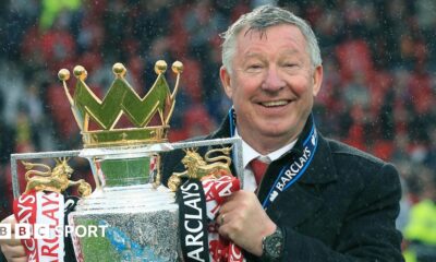 Sir Alex Ferguson holding the Premier League trophy