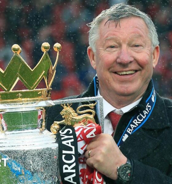 Sir Alex Ferguson holding the Premier League trophy