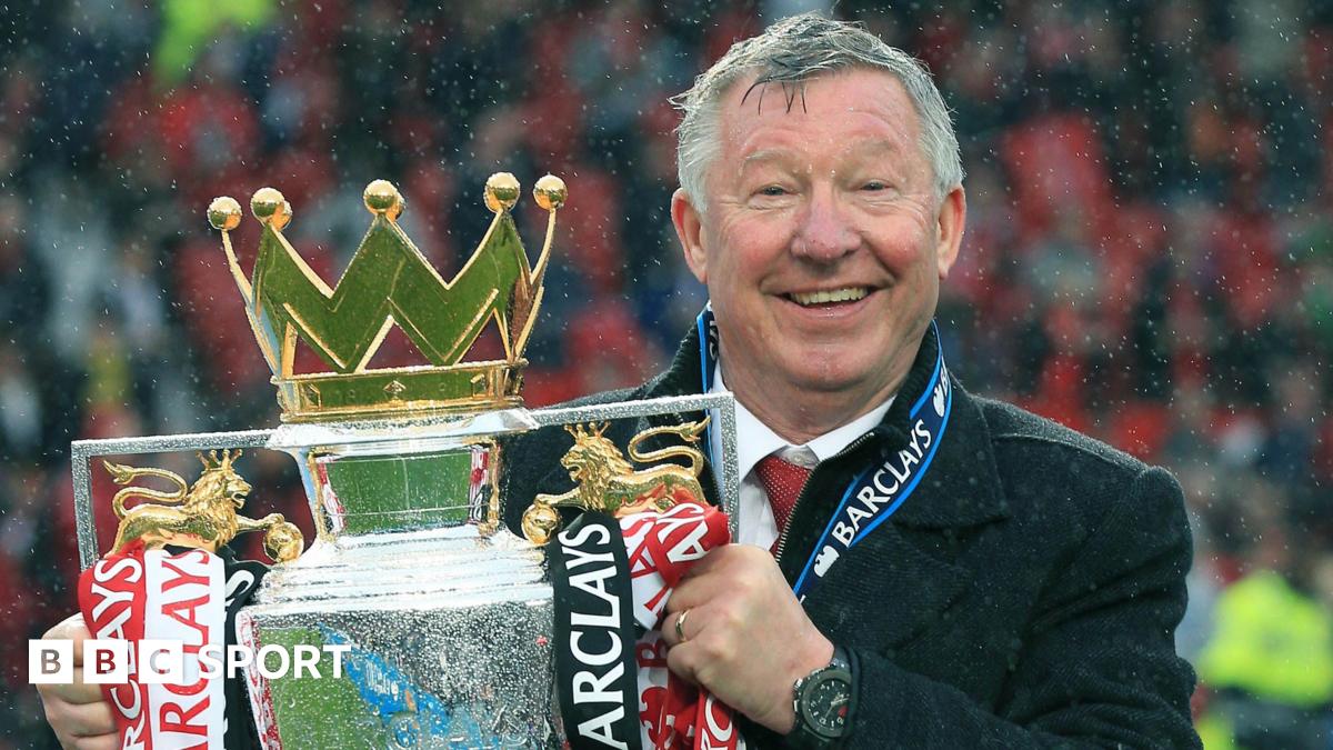 Sir Alex Ferguson holding the Premier League trophy