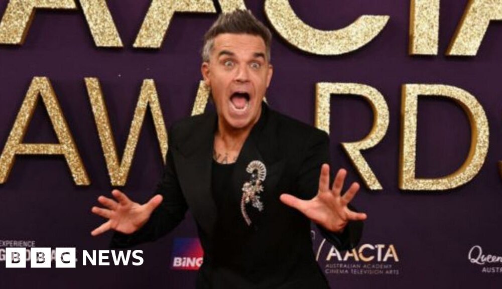 Take That singer Robbie Williams surprises 94-year-old fan