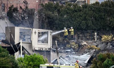 Wildfires destroy 40 homes and kill a firefighter in Australia