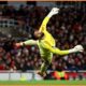 Arsenal goalkeeper David Raya makes a save from Brighton