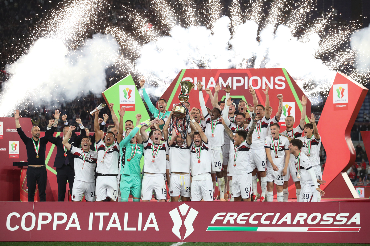 ROME, ITALY - MAY 14: Lewis Ferguson, Lorenzo De Silvestri and Riccardo Orsolini of Bologna lift the Coppa Italia trophy as their team mates celebrate after the team