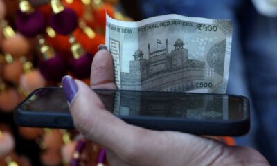 Rupee cracks below 90 to the dollar, hit by tariffs, capital outflows