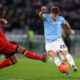 ROME, ITALY - NOVEMBER 23: Toma Basic of Lazio shoots past Ylber Ramadani of Lecce during the Serie A match between SS Lazio and US Lecce at Stadio Olimpico on November 23, 2025 in Rome, Italy. (Photo by Paolo Bruno/Getty Images)