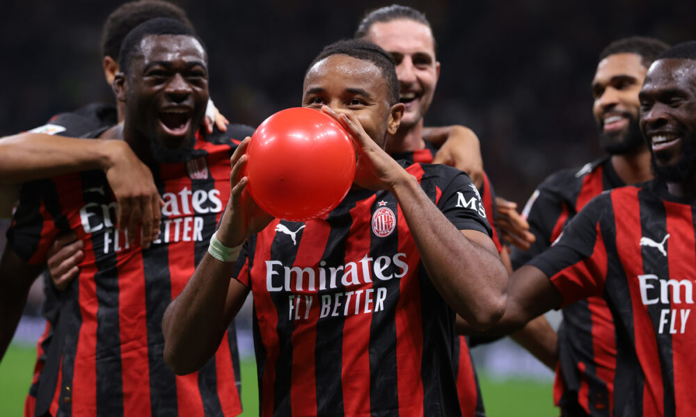 MILAN, ITALY - SEPTEMBER 23: Christopher Nkunku of AC Milan inflates a balloon as he celebrates with teammates after scoring to give the side a 2-0 lead during the Coppa Italia Frecciarossa Round of 16 match between AC Milan and US Lecce at Giuseppe Meazza Stadium on September 23, 2025 in Milan, Italy. (Photo by Jonathan Moscrop/Getty Images)