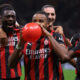 MILAN, ITALY - SEPTEMBER 23: Christopher Nkunku of AC Milan inflates a balloon as he celebrates with teammates after scoring to give the side a 2-0 lead during the Coppa Italia Frecciarossa Round of 16 match between AC Milan and US Lecce at Giuseppe Meazza Stadium on September 23, 2025 in Milan, Italy. (Photo by Jonathan Moscrop/Getty Images)