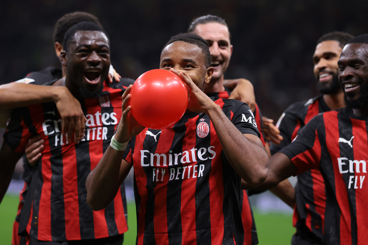 MILAN, ITALY - SEPTEMBER 23: Christopher Nkunku of AC Milan inflates a balloon as he celebrates with teammates after scoring to give the side a 2-0 lead during the Coppa Italia Frecciarossa Round of 16 match between AC Milan and US Lecce at Giuseppe Meazza Stadium on September 23, 2025 in Milan, Italy. (Photo by Jonathan Moscrop/Getty Images)