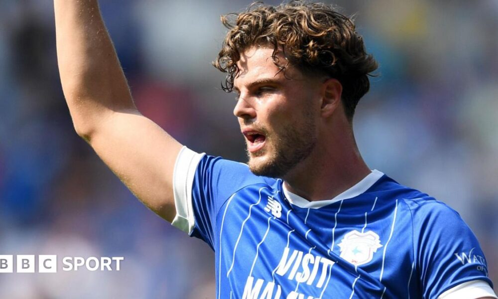 Ollie Tanner raises his right arm