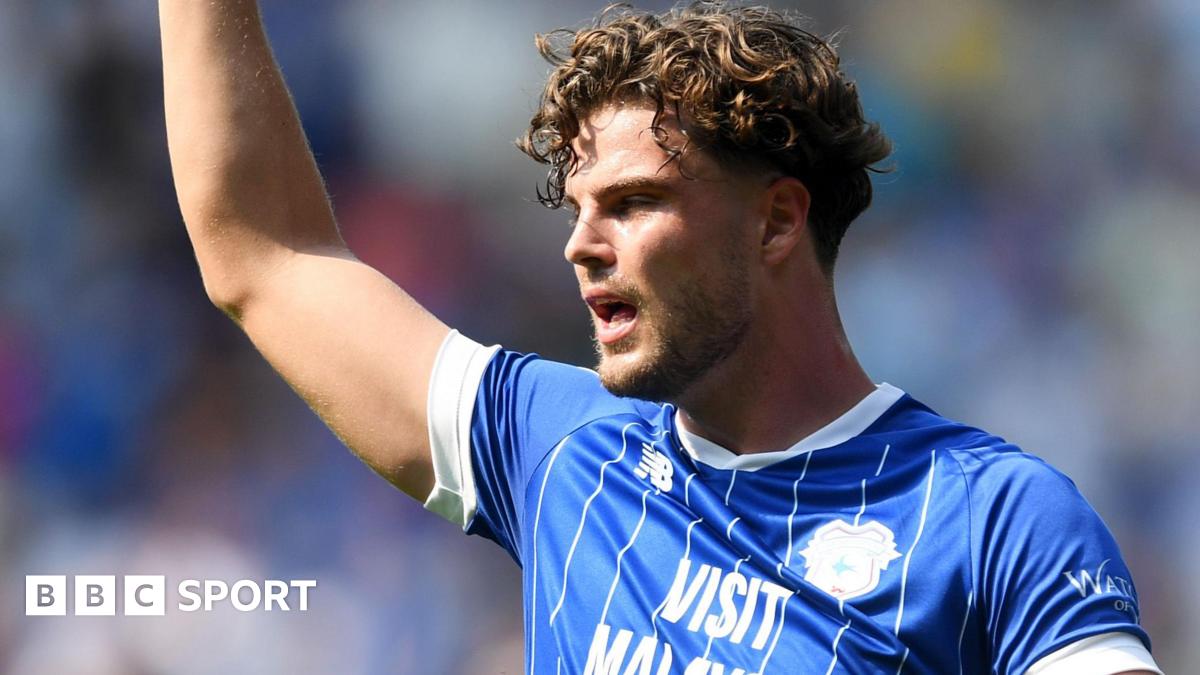 Ollie Tanner raises his right arm