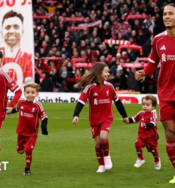 Virgil van Dijk of Liverpool enters the pitch with the children of former player Diogo Jota prior to the Premier League match between Liverpool and Wolves