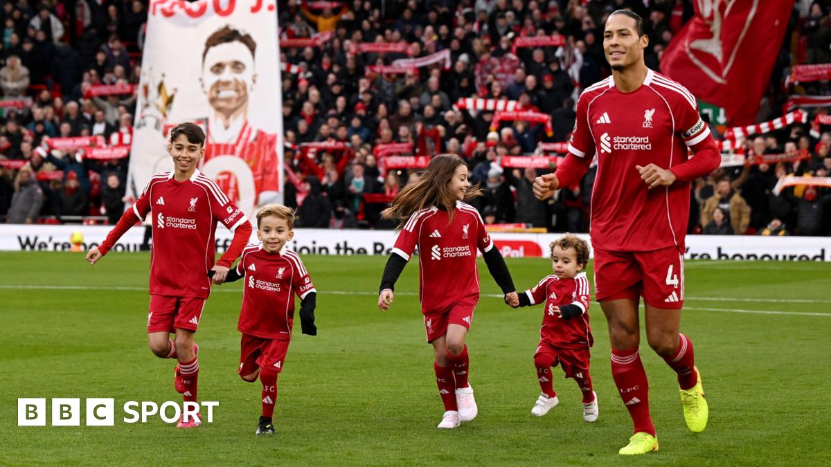 Virgil van Dijk of Liverpool enters the pitch with the children of former player Diogo Jota prior to the Premier League match between Liverpool and Wolves