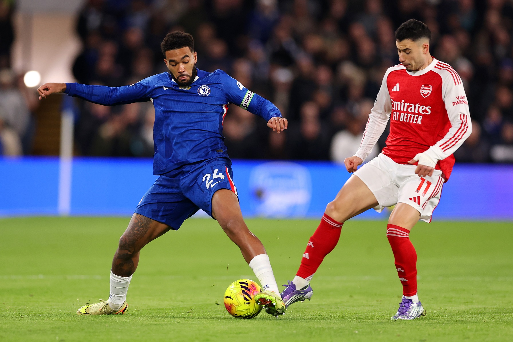 Reece James of Chelsea is challenged by Gabriel Martinelli of Arsenal